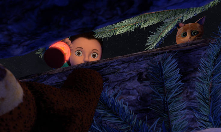 Girl and kitten looking through a gap at a toy cuddly bear